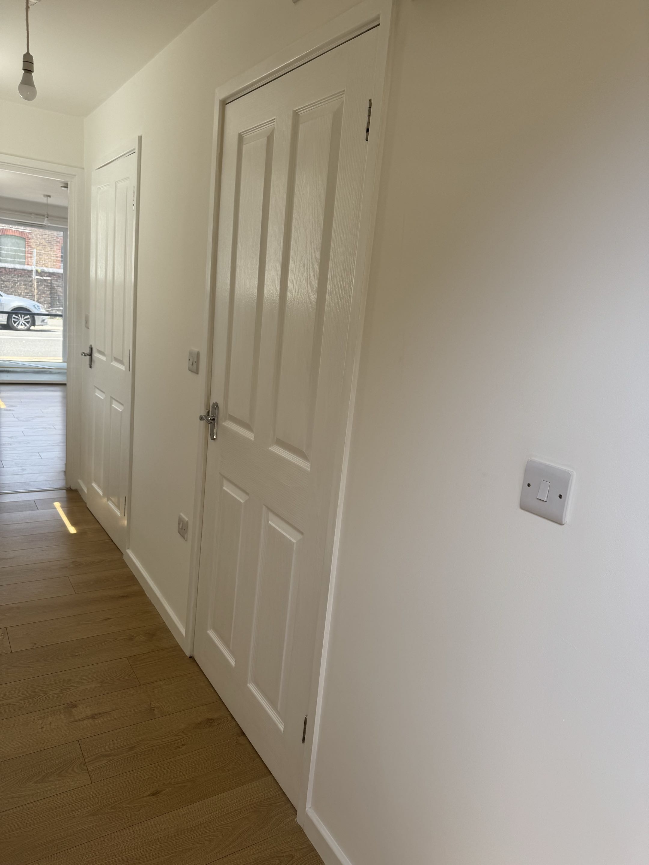 Freshly painted apartment hallway walls and interior doors