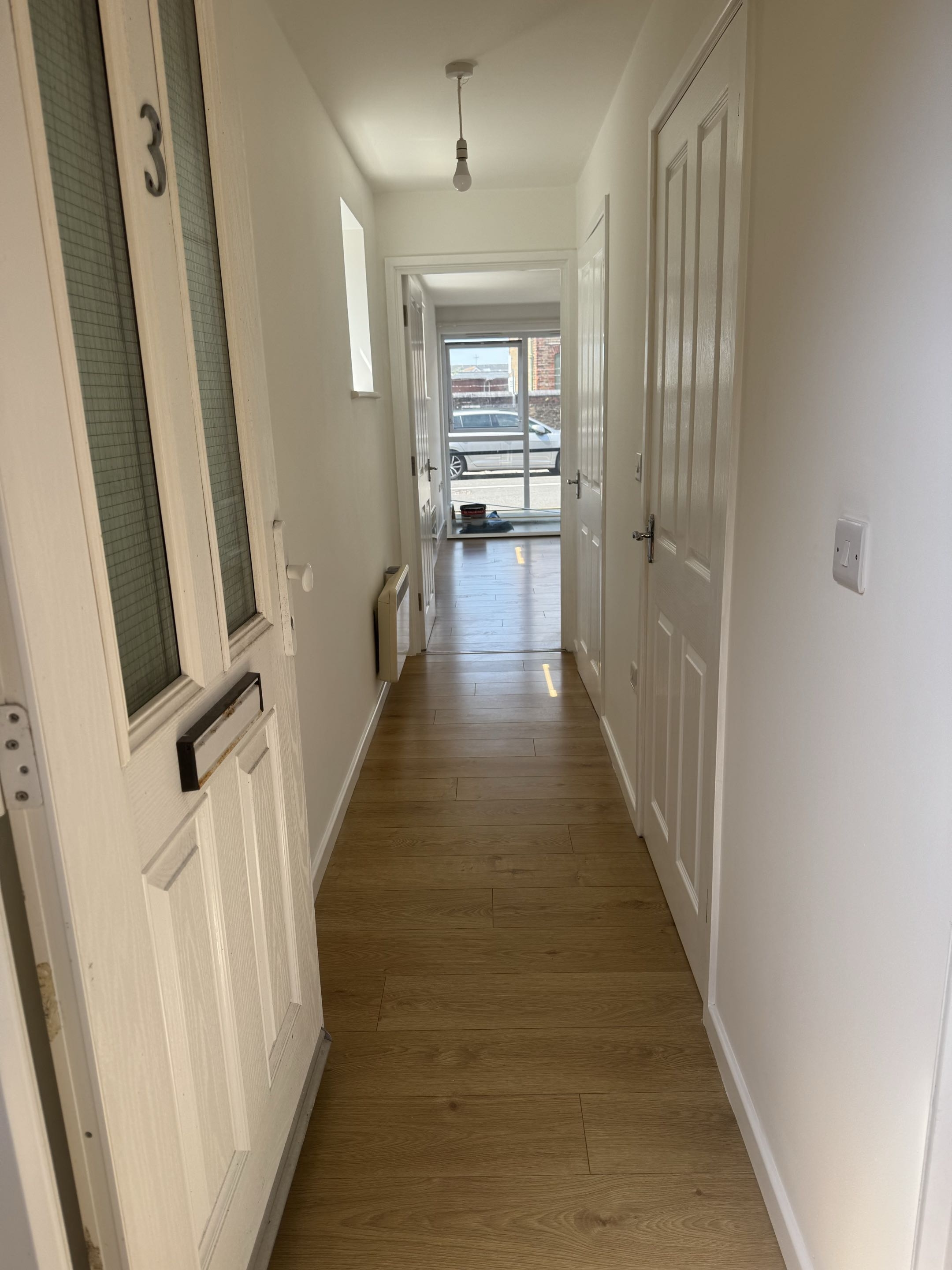 Redecorated apartment entrance hallway with clean white paintwork