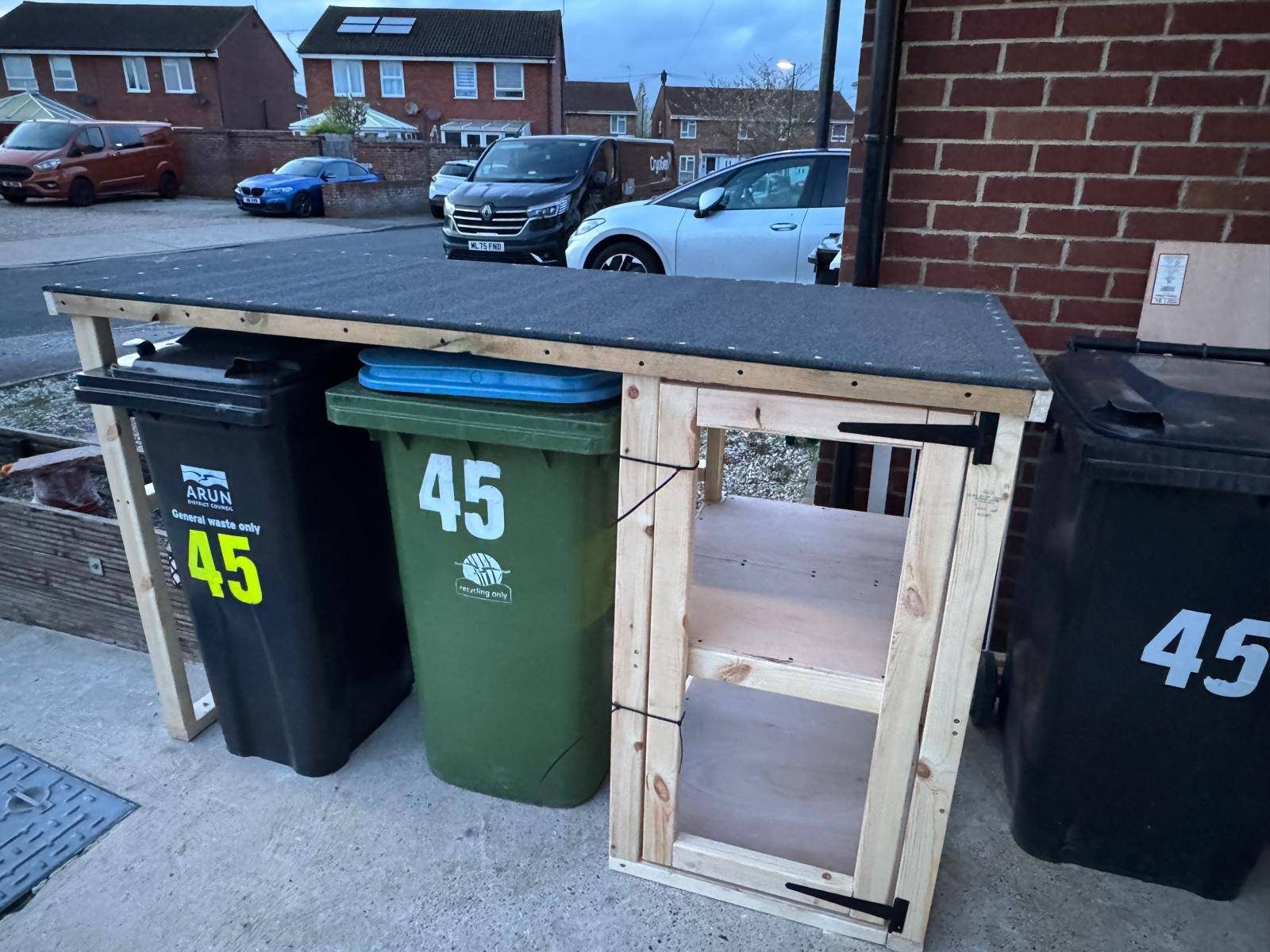 Bin store door being fitted during construction