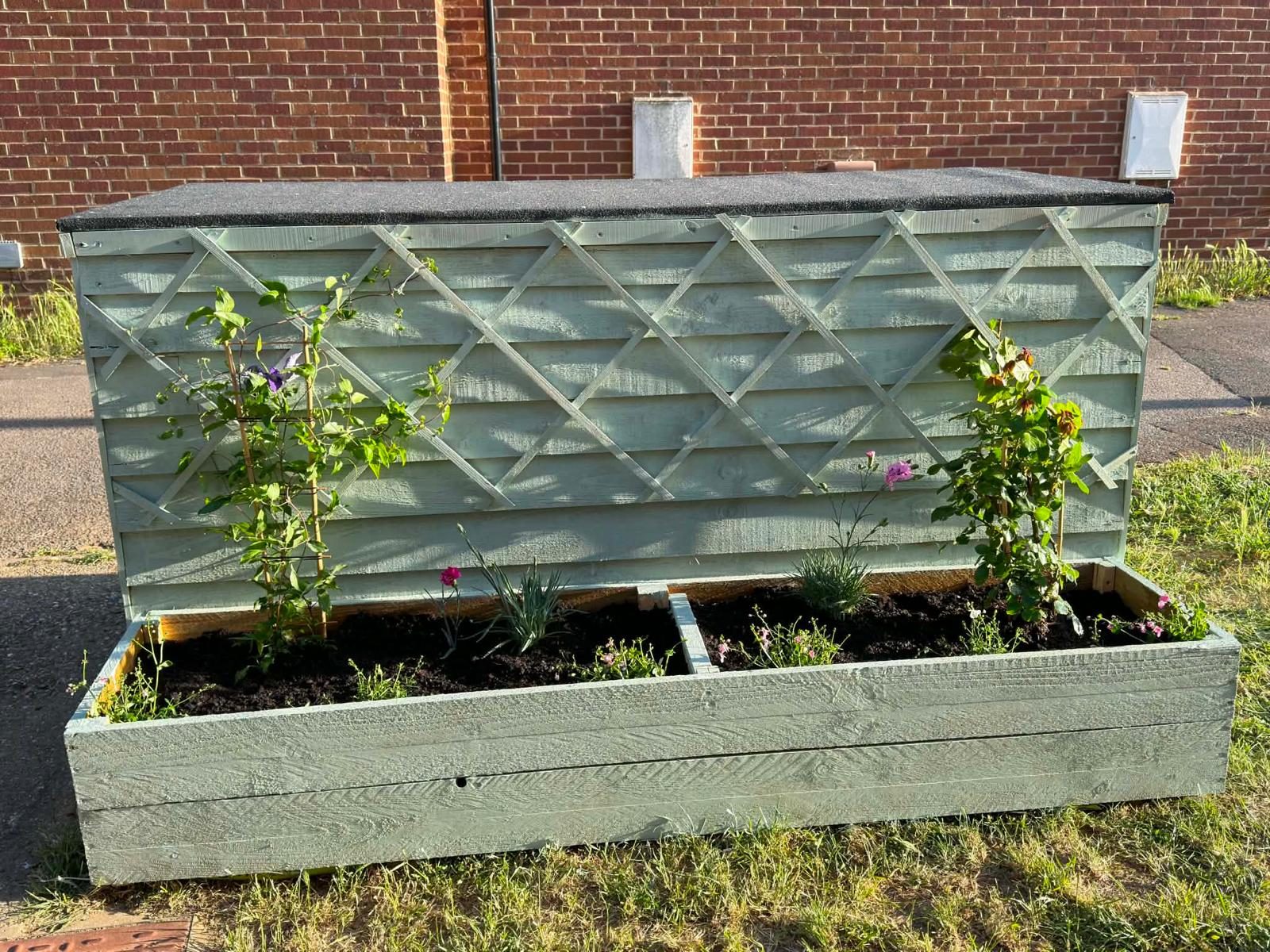 Close up of planted front planter with trellis