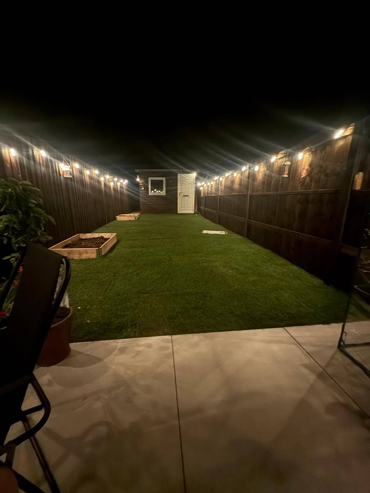 Finished garden with evening lighting after outdoor makeover