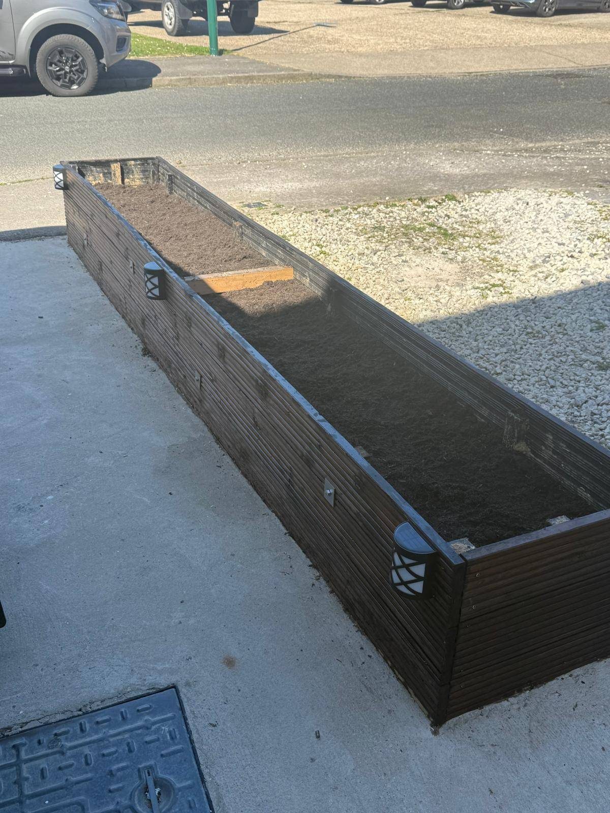 Raised timber planter near front garden area